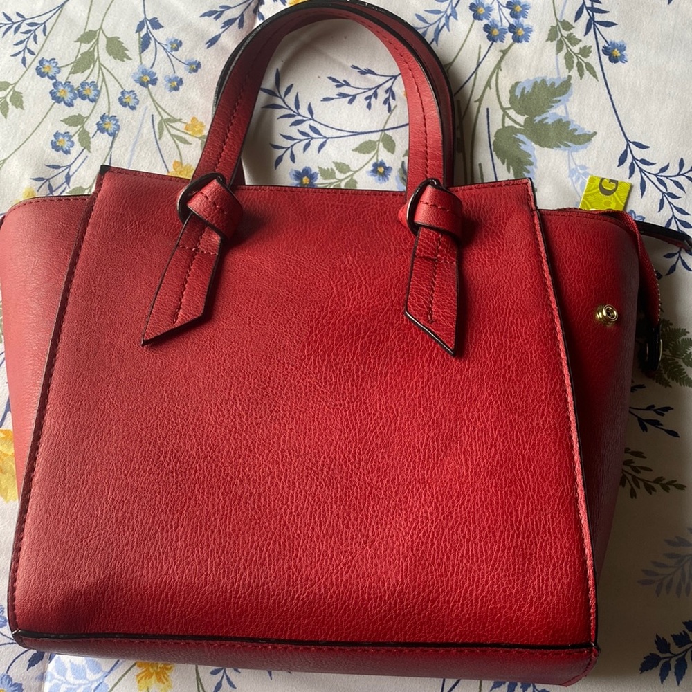 It’s a brand new red bag from Gianni Bini